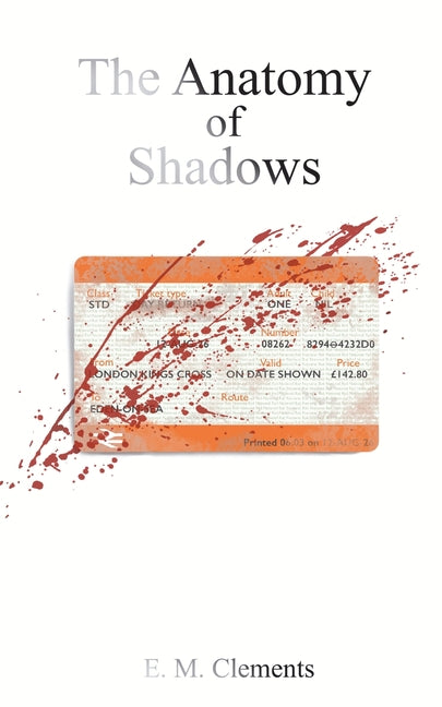 Paperback copy of The Anatomy of Shadows by E.M. Clements, showing the front cover with dark, shadowy artwork.