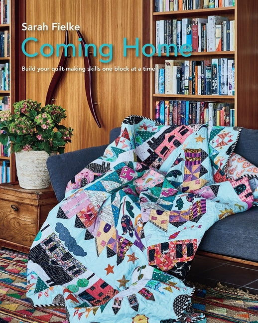 Paperback Coming Home Quilt Pattern book by Blurb featuring instructional videos for building quilt-making skills with detailed block guidance.