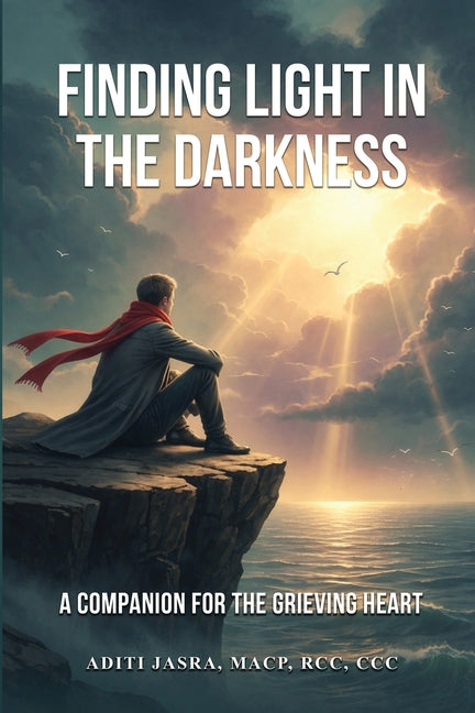 Paperback copy of "Finding Light in the Darkness" by Aditi Jasra, a comforting guide for the grieving heart.