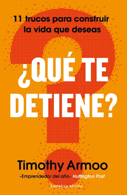 Paperback book titled "Qué Te Detiene?" by Urano World, featuring a cover with bold text and vibrant colors.