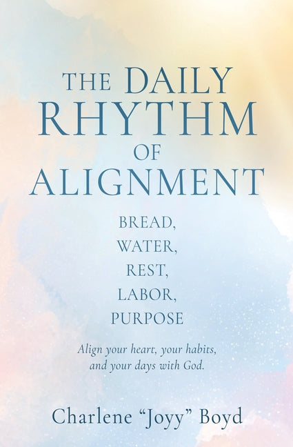 Paperback titled "The Daily Rhythm of Alignment" by Xulon Press, featuring a cover with images of bread, water, and a person resting.