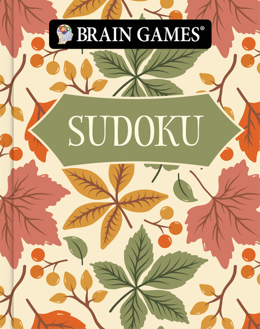 Paperback Brain Games Sudoku book with an autumn-themed cover by Publications International, Ltd. for on-the-go puzzle fun.