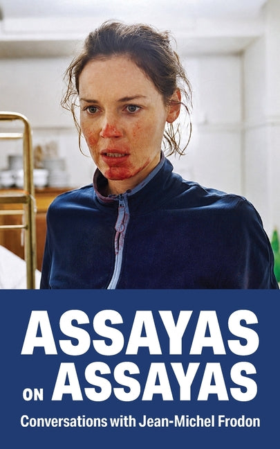 Paperback copy of Assayas on Assayas by Sticking Place Books, featuring the book cover with title and author details.