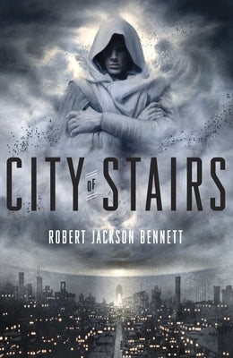 Paperback copy of City of Stairs by Del Rey Books, showing the front cover with cityscape artwork and book title.
