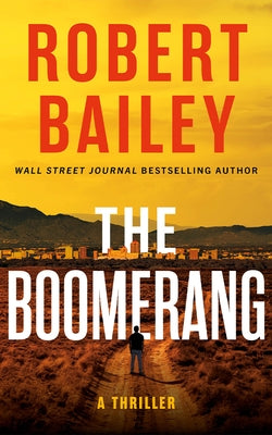 Paperback copy of The Boomerang thriller novel by Thomas & Mercer, featuring a dark, suspenseful cover design.