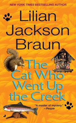 Mass market paperback of "The Cat Who Went Up the Creek" by Penguin Publishing Group, showing the book cover with colorful illustration.