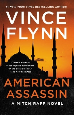 Paperback copy of American Assassin: A Thriller by Atria Books, featuring a dark cover with intense imagery.