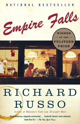 Vintage Empire Falls paperback book placed on a table with a blurred background, showcasing its cover design.