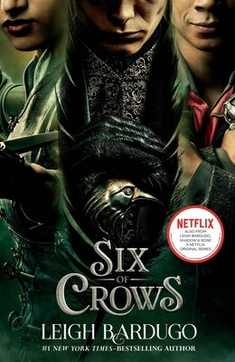 Paperback copy of Six of Crows by Henry Holt & Company, featuring the book's cover art with dark and mysterious imagery.