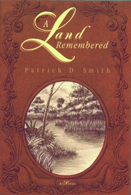 Paperback copy of A Land Remembered by Pineapple Press, featuring the book's cover with tropical landscape artwork.