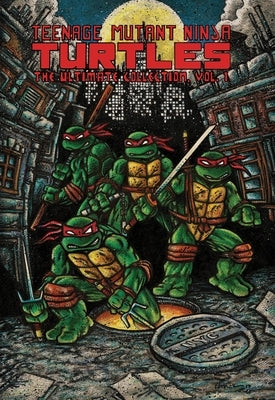 Paperback copy of Teenage Mutant Ninja Turtles: The Ultimate Collection, Vol. 1, published by IDW Publishing, featuring colorful comic art.