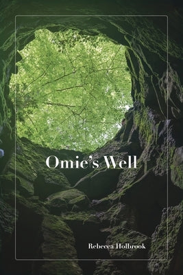 Paperback copy of Omie's Well by Dancing Heron Publishing, featuring the book cover with colorful artwork.