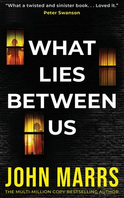 Cover of the paperback novel "What Lies Between Us" by Thomas & Mercer, featuring dark, mysterious artwork.