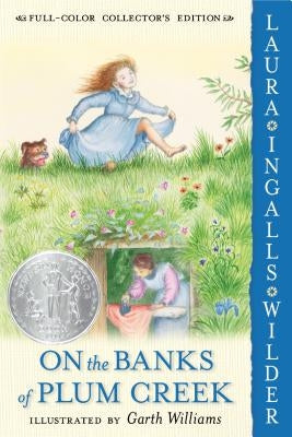 Paperback copy of "On the Banks of Plum Creek" by HarperCollins, showing the book cover with title and illustration.
