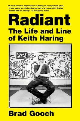 Paperback book titled "Radiant: The Life and Line of Keith Haring" by Harper Perennial featuring vibrant cover art of Keith Haring's artwork.