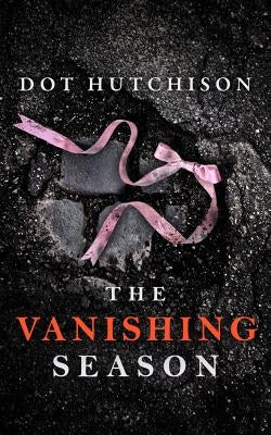 Paperback of The Vanishing Season by Thomas & Mercer, showing the book cover with dark tones and title text visible.