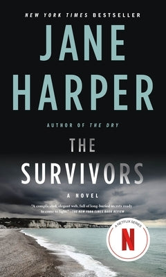Paperback copy of "The Survivors" by Flatiron Books, featuring the book cover with dark and moody artwork.