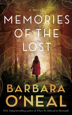 Paperback copy of Memories of the Lost by Lake Union Publishing featuring a book cover with a scenic landscape design.