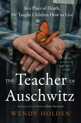 Paperback copy of "The Teacher of Auschwitz" by Harper Perennial, featuring the book cover with title and author details.