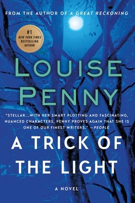 Paperback of "A Trick of the Light" by Minotaur Books, featuring the book cover with dark and mysterious artwork.