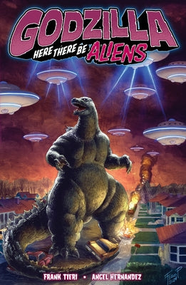 Paperback of Godzilla: Here There Be Aliens comic book by IDW Publishing featuring cover art with Godzilla and alien imagery.
