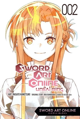 Paperback manga copy of Sword Art Online Unital Ring Vol. 2 by Yen Press, featuring cover art with characters from the series.