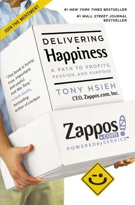 Paperback of "Delivering Happiness" by Grand Central Publishing showing the book cover with title and author details.