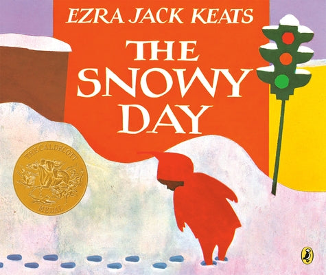 Paperback copy of "The Snowy Day" by Puffin Books featuring a snowy scene on the cover.