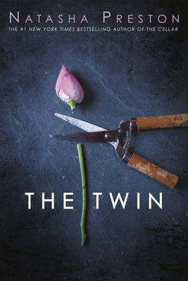Paperback copy of "The Twin" by Delacorte Press showing the book cover with title and author’s name.