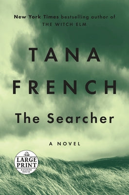 Paperback of The Searcher by Random House Large Print Publishing, featuring a cover with a scenic landscape and bold title text.