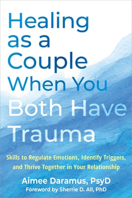 Paperback book titled "Healing as a Couple When You Both Have Trauma" by New Harbinger Publications, featuring a calming cover design.