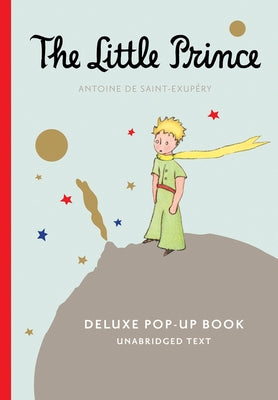 Open paperback of The Little Prince Deluxe Pop-Up Book by Clarion Books showing colorful pop-up illustrations inside.