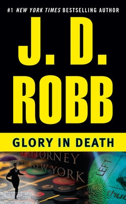 Mass market paperback of "Glory in Death" by Berkley Books, featuring the book cover with title and author details.