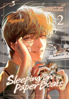 Paperback copy of "Sleeping on Paper Boats, Vol. 2" by Sublime, featuring the book cover with artistic design.