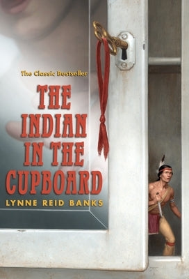 Paperback copy of "The Indian in the Cupboard" by Yearling Books, showing the front cover with colorful illustrations.