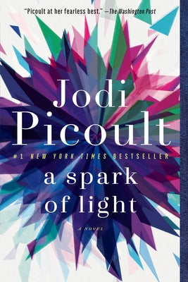 Paperback copy of "A Spark of Light" by Ballantine Books featuring the book cover with title and author details.