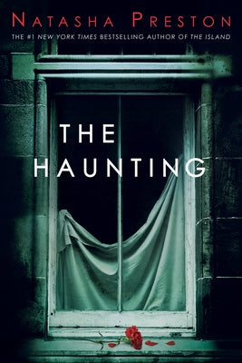 Paperback copy of The Haunting novel by Delacorte Press, featuring eerie cover art and ghostly imagery.
