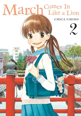 Paperback of March Comes in Like a Lion, Volume 2 manga by Denpa Books featuring colorful cover art with characters and Japanese text.