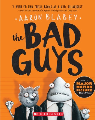 Paperback copy of The Bad Guys Volume 1 by Scholastic Press, featuring colorful cover art with cartoon characters.