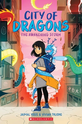 Paperback graphic novel "The Awakening Storm" from Graphix, featuring vibrant cover art of the City of Dragons series.