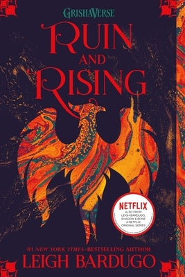Paperback of "Ruin and Rising" by Square Fish, featuring the book cover with dark and fiery artwork.