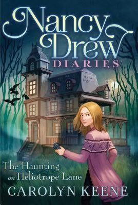 Paperback copy of "The Haunting on Heliotrope Lane" by Aladdin Paperbacks with a spooky cover illustration.