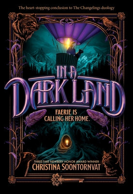 Paperback copy of "In a Dark Land" by Sourcebooks Young Readers, featuring dark, atmospheric cover art.