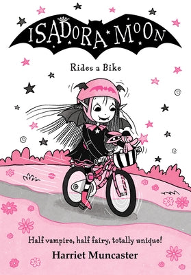 Isadora Moon riding a pink bicycle in a colorful outdoor setting, from the Oxford Children's paperback book "Isadora Moon Rides a Bike."