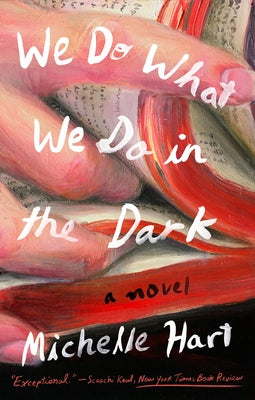Paperback of "We Do What We Do in the Dark" by Riverhead Books, showing the book cover with dark and mysterious design elements.