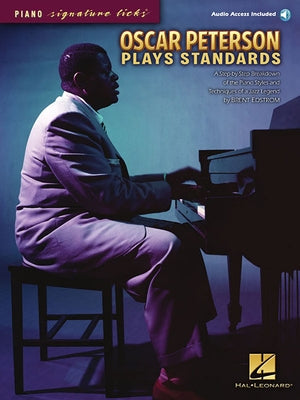 Paperback book titled Oscar Peterson Plays Standards by Hal Leonard Publishing Corporation, featuring sheet music and a CD insert.