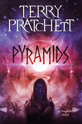Paperback copy of "Pyramids," a Discworld novel by Harper Perennial, with a cover featuring pyramids and desert imagery.