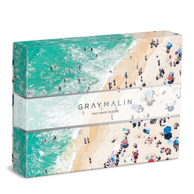 Gray Malin The Seaside 1000-piece puzzle by Galison, featuring vibrant beach scenes and colorful artwork, laid out on a flat surface.