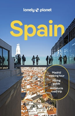 Paperback Lonely Planet Spain travel guide with detailed maps and insights, featuring the Lonely Planet brand on the cover.