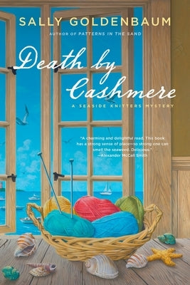 Paperback copy of "Death by Cashmere: A Seaside Knitters Mystery" by Berkley Books, featuring a cover with seaside and knitting imagery.